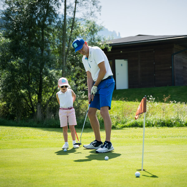 Man and child on the green